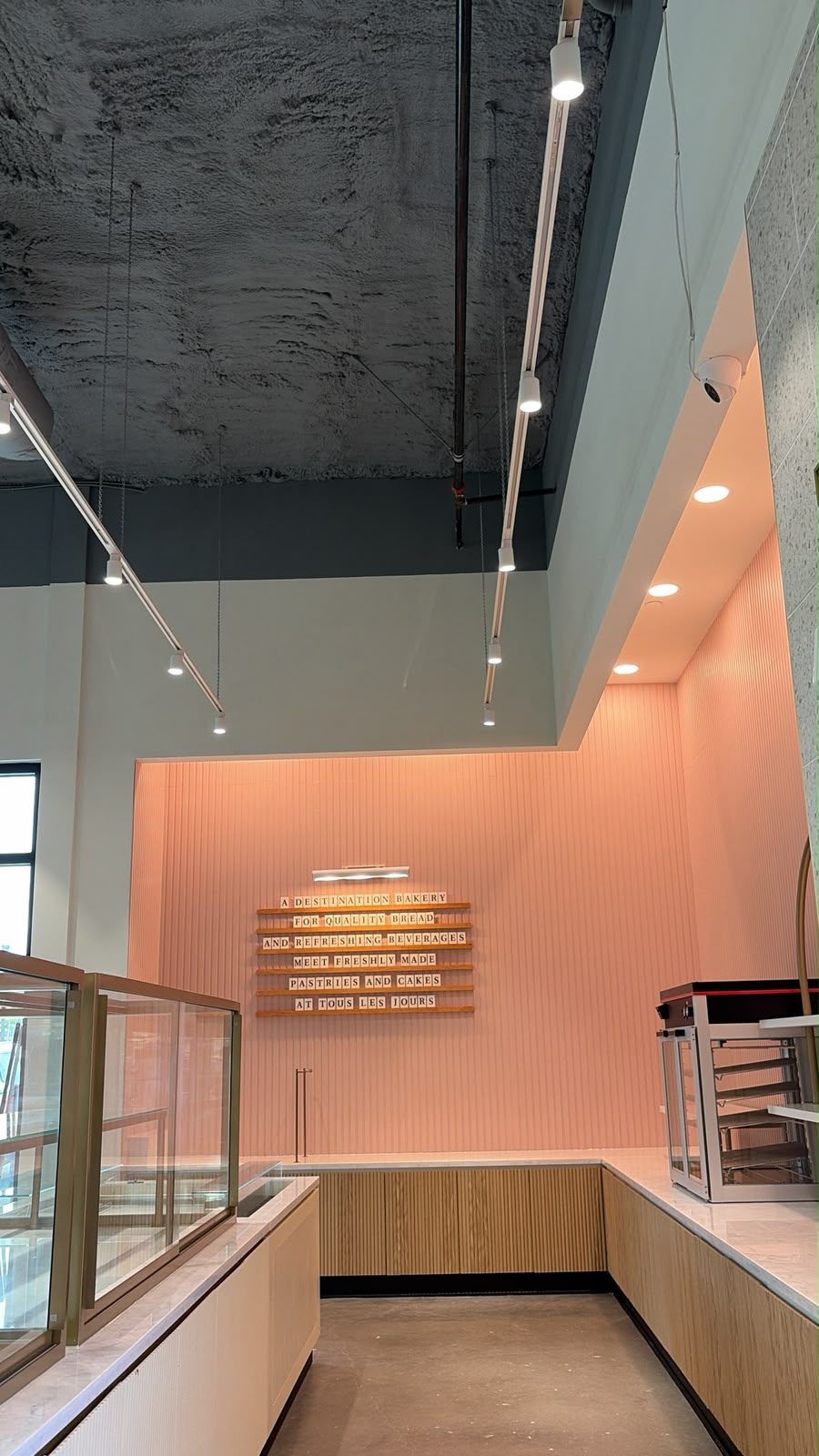 Bakery display area with overhead track and recessed lighting