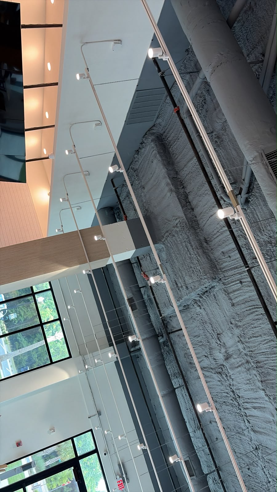 Ceiling track lights across a bakery interior, correctly oriented