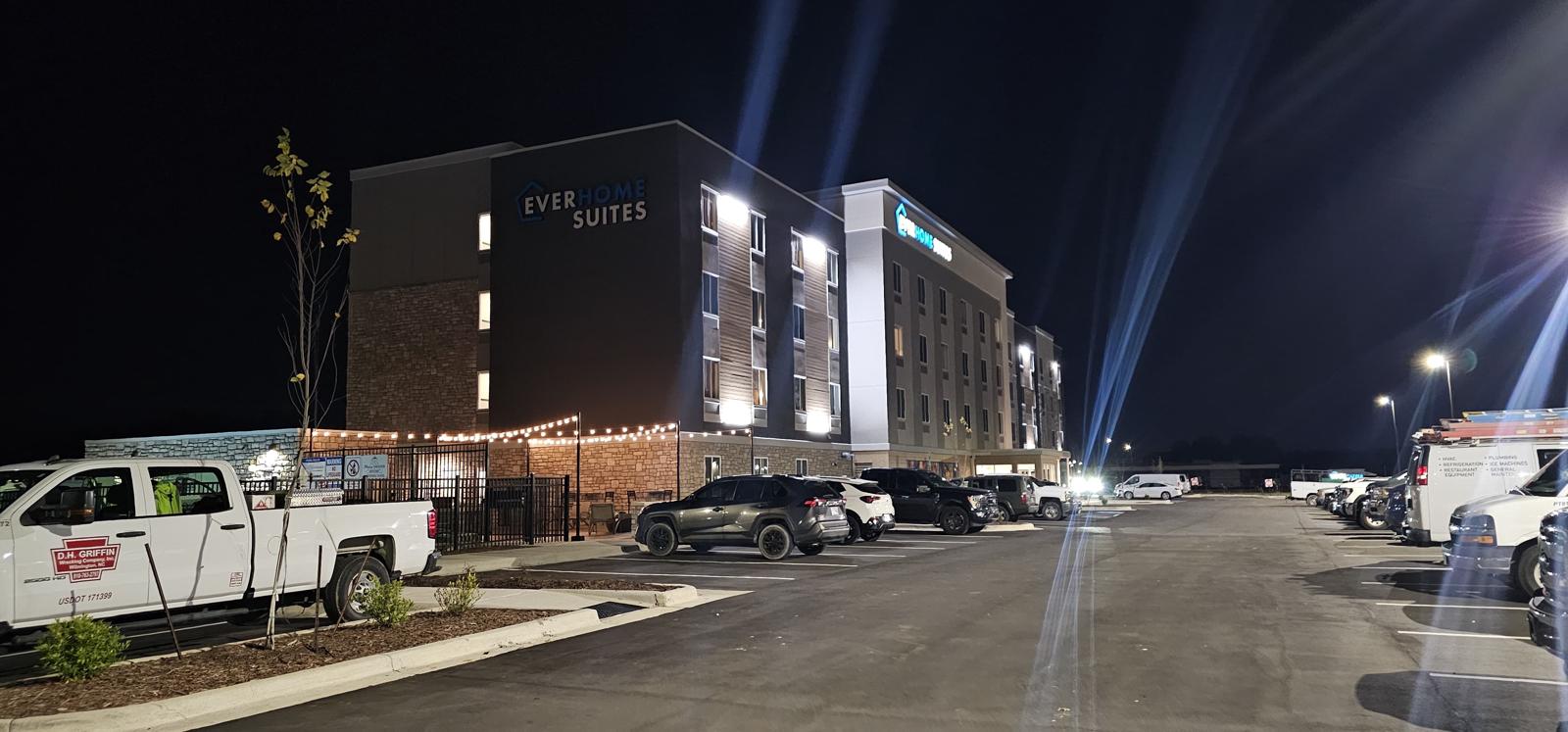 Everhome Suites hotel exterior with illuminated facade at night