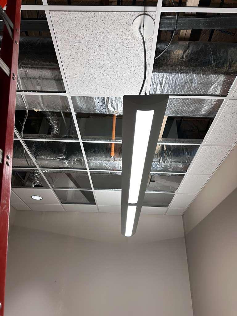 Suspended linear light fixture in an unfinished commercial interior